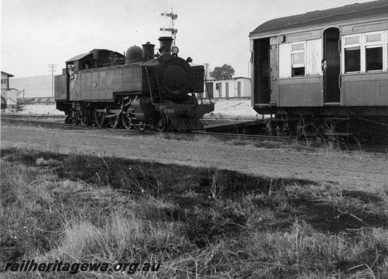 P17715
DD class 599 steam locomotive, side and front view, end of AYB class suburban brake saloon carriage, semaphore signals.
