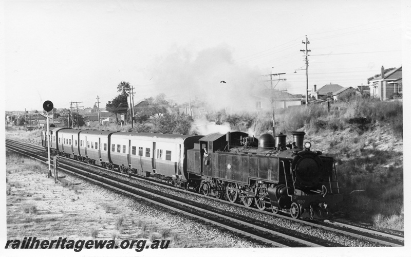 P17720
DD class 597 steam locomotive, side and front view, on suburban passenger working, search light signal, near Rivervale, SWR line.
