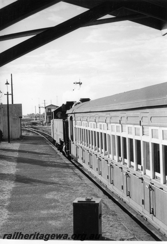 P17725
DD class steam locomotive on suburban passenger working, platform, signal box, yard lamp, signals.
