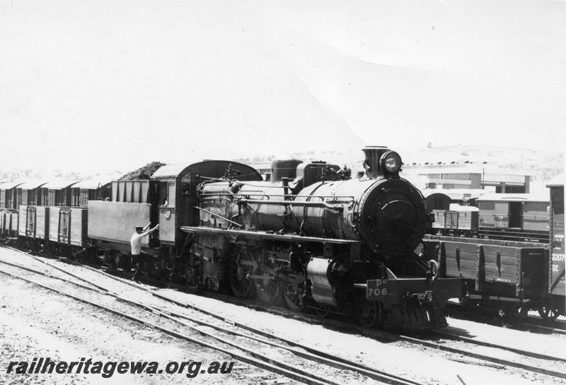 P17737
PM class 706 steam locomotive arriving Avon Yard with 96 goods train from Merredin. EGR line. Note the varied freight wagons next to the locomotive and in the background is the Avon diesel loco shed. 
