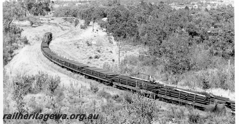 P17749
5 of 9 Rail reclamation on old ER line. C class 1701, short hood leading, on reclamation train laden with rails, approaching pipe bridge, Swan View, ER line
