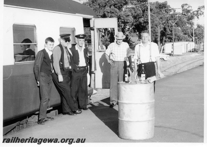 P17796
Group of railway staff, on platform beside Midland to Chidlow railcar, ER line, small commemoration of the second to last service
