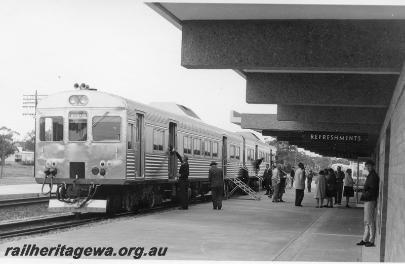 P17820
3 of 5 of ADK class 690 & 684 railcars pictured at the 'new' Northam Station. EGR line. Note the Refreshment signage attached to the awning and the metal steps allowing access to the railcars. Front view of railcar. 
