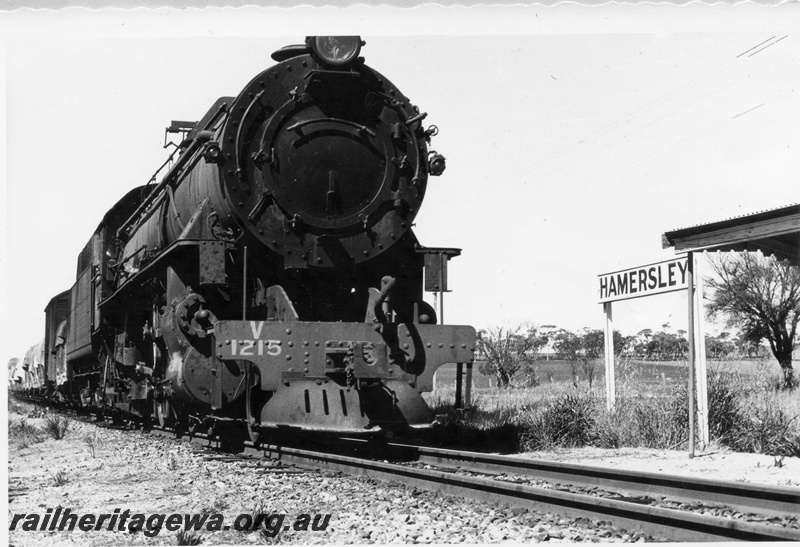 P17833
V class 1215 steam locomotive working 24 goods from York arriving at Hamersley to perform safe working duties. GSR line. Note the siding nameboard and portion of the building roof.
