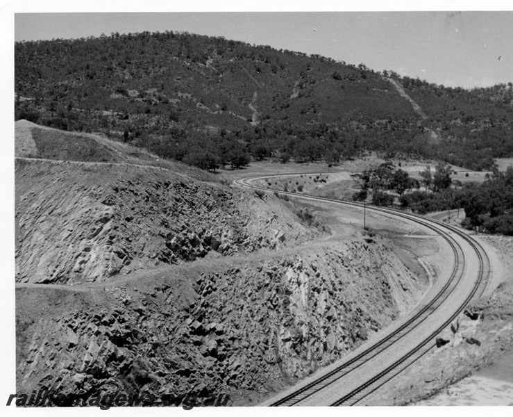 P17858
Windmill Hill cutting east of Toodyay as seen from the top of the cutting. This is the western end of the cutting and the line can be seen in the background curving in a 