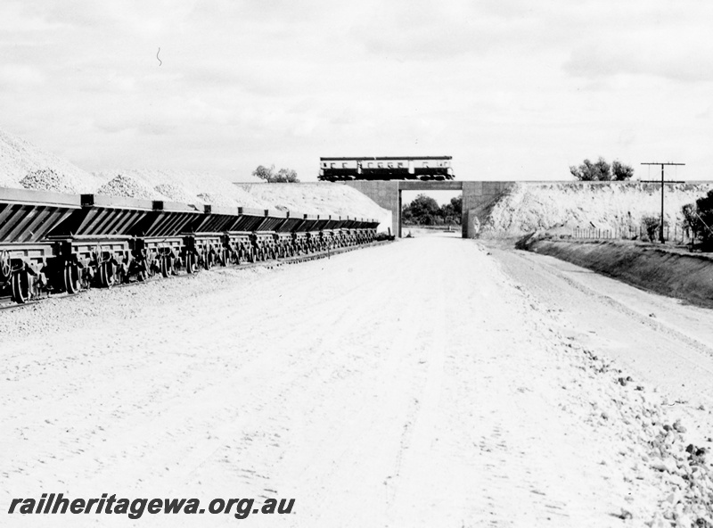 P17872
An unidentified ADG class railcar crossing the Kenwick Flyover enroute to Armadale. SWR line. Note the loaded LA class ballast hoppers awaiting distribution as part of the standard gauge project.
