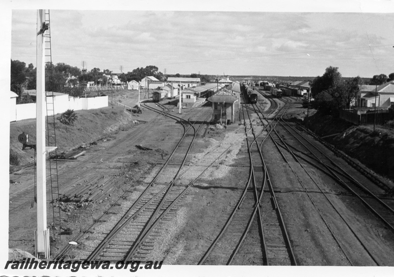 P17894
Station and yard, signal, trackwork, Kalgoorlie, ER line, showing recently completed standard gauge line running through the yard, view from overhead road bridge
