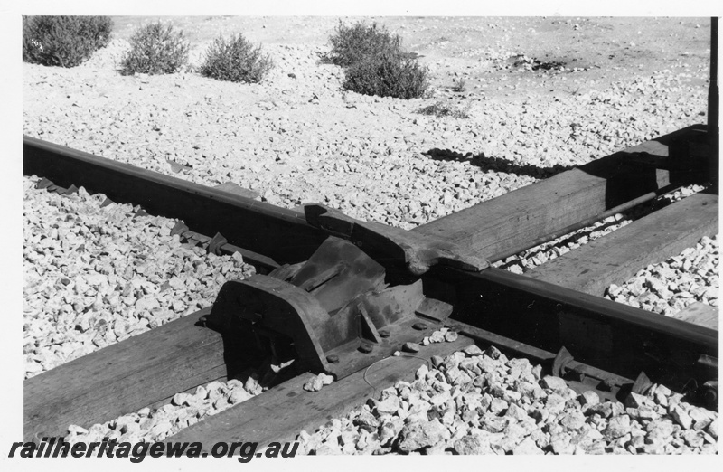 P17903
2 of 2 Newgold crossing near Port Hedland airport, view of derailer installed on the Mount Newman Railroad line on one side of the crossing. A similar derailer was installed on the other side of the crossing as well, since Goldsworthy trains had right of way as that line was constructed first
