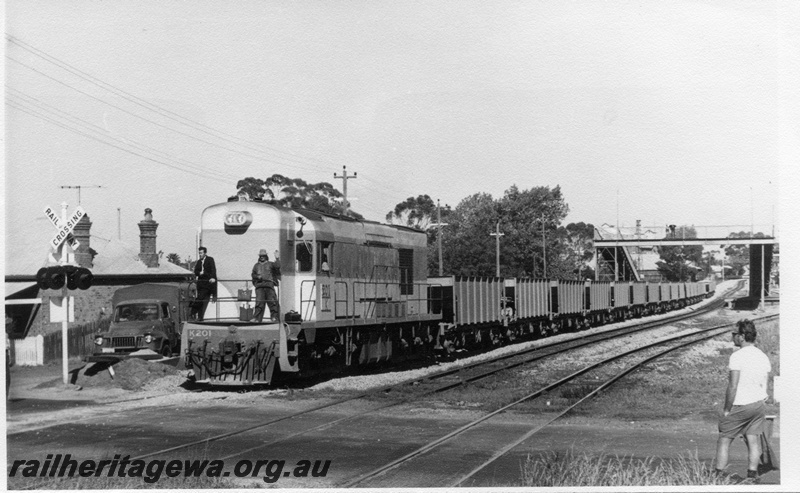 P17911
3 of 3 Ballast working at East Guildford, K class 201 on ballast train, workmen on front platform of loco, level crossing, overhead footbridge, East Guildford, ER line
