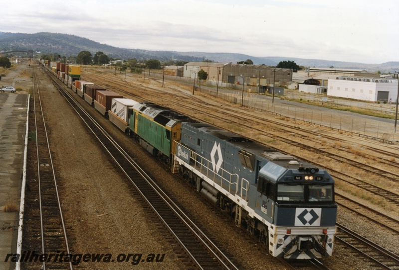 P17999
NR class 58, AN class 4, double heading westbound interstate freight train, disused platform, workshop buildings, Midland, ER line
