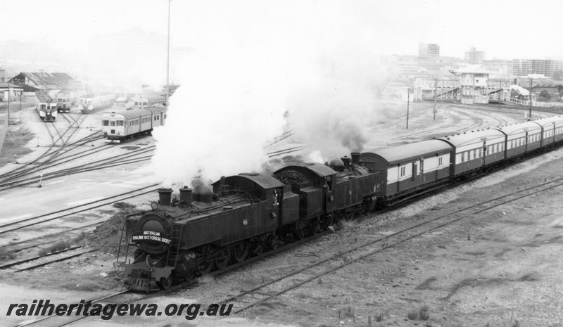 P18019
1 of 4 images of the ARHS Tour to Coolup, DM class 587 and DD class 592, double heading the tour train, DMU depot, overhead footbridge, city buildings in the background, East Perth, SWR line
