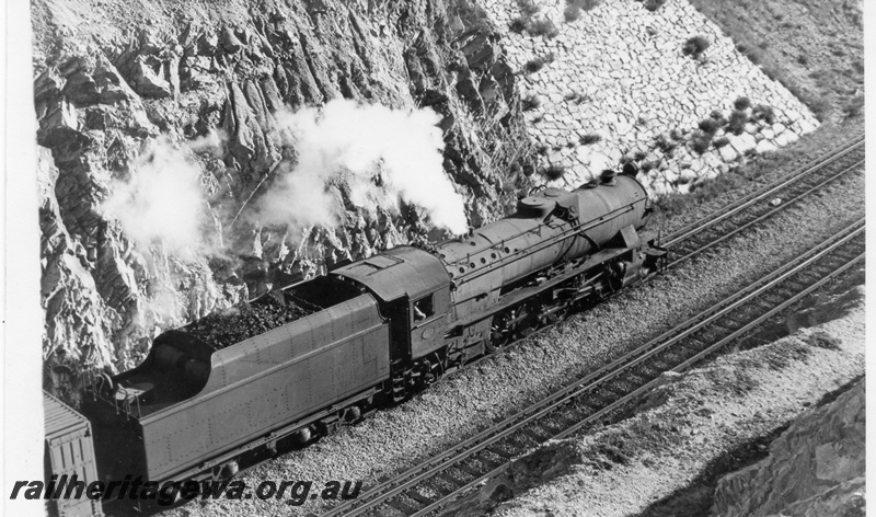 P18211
1 of 2, V class 1215 steam locomotive, elevated side view, on the No.24 goods train, Windmill Hill Cutting, Avon Valley line. Same as P5486
