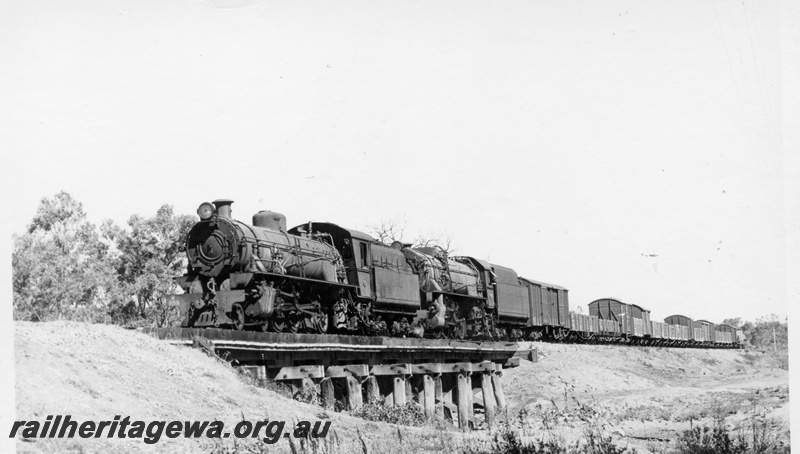 P18217
W class 959 steam locomotive double heading with V class 1220 steam locomotive on the No.12 goods train, front and side view, crossing the Hotham River trestle bridge
