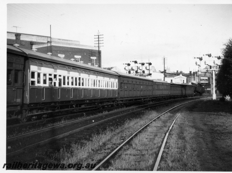 P18321
Tank loco on suburban passenger service, old style stock on peak hour working, bracket signals, side and end view, moving away from camera
