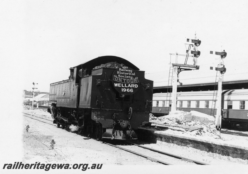 P18406
3 of 5 images of DD class 592 on ARHS tour train to Wellard, loco off train, tender first to camera, carriages at adjacent platform, bracket signals
