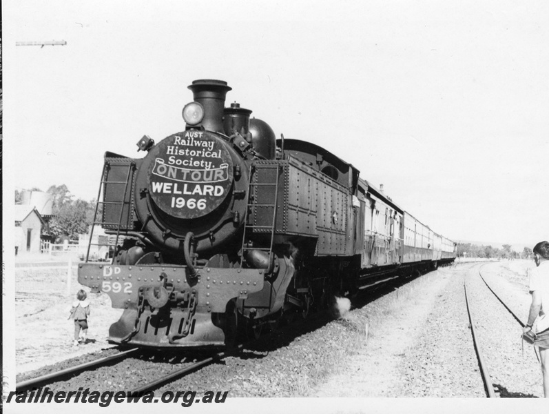 P18408
5 of 5 images of DD class 592 on ARHS tour train to Wellard, loco front first heading train, photographer and small girl standing trackside, front and side view 
