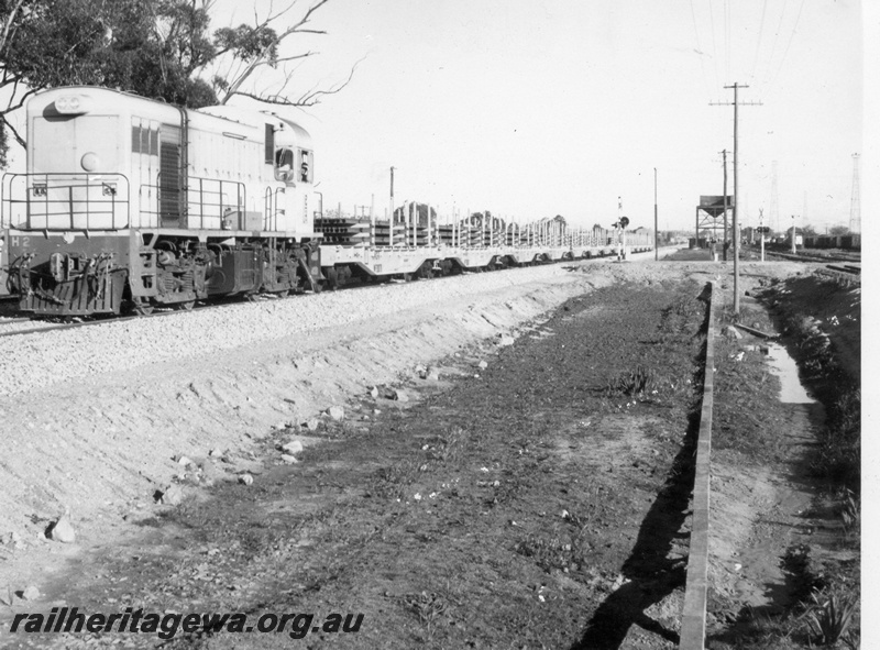 P18431
H class 2, on freight train, level crossing, water tower, signal, front and side view
