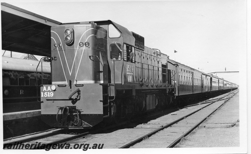 P18472
3 of 12 images relating to the ceremony for the linking of the standard gauge railways at Kalgoorlie, AA class 1519, on special 19 car train which brought Perth guests to the ceremony, front and side view. Train comprised AZS class 445, Z class 9, AV class 425, AV class 286, AVL class 314, AYL class 29, AQZ class 423, AGZ class 416, AZ class 443, AZ class 440, AZ class 437, AGS class 22, AH class 563, AH class 562, AH class 560, AL class 4, AM class 313, AM class 414, ZJA class 431
