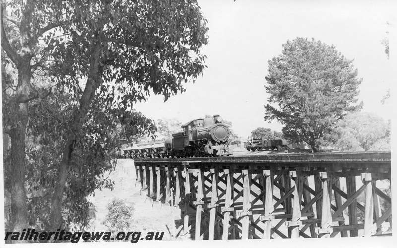P18552
FS class 452, on ballast train, crossing wooden trestle bridge, RAC class 5684 on siding, Boyanup, side and front view
