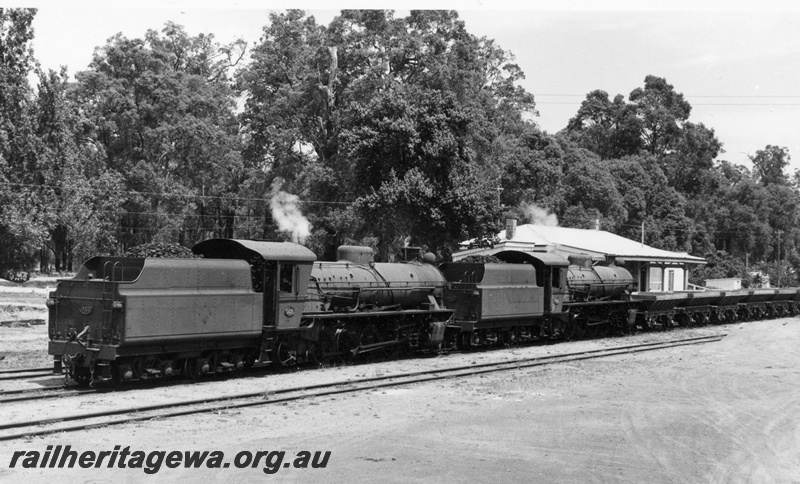 P18596
W class 937, W class 917, tenders leading, on rake of wagons, station building, Greenbushes, PP line, rear and side view
