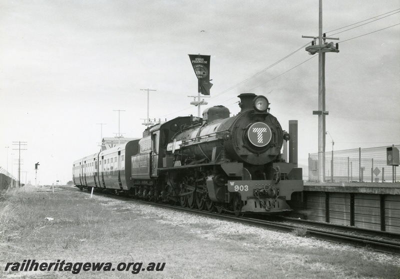 P18625
W class 903 'Marrinup' steam locomotive hauling a Transperth 'Spinnaker Flyer' at South Beach Station. Coaches are SS class 4 'Blackbutt' and 3 'Wandoo' with SSD class 1 'Jarrah'. Locomotive and coaches owned by Hotham Valley Tourist Railway.
