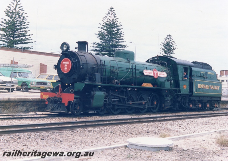P18626
W class 903 'Marrinup' steam locomotive moving forward at Fremantle onto the 'Spinnaker Flyer' train. The locomotive carries a signboard designating it as 'Spinnaker Steamer'.
