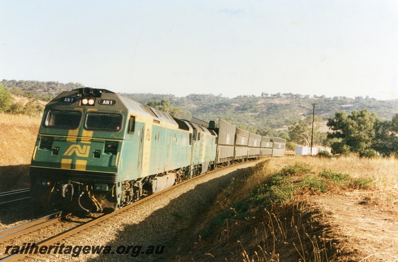 P18633
AN class 1 and DL class 48 diesel locomotives at the head of a Melbourne bound standard gauge freight train at the 83 kilometre mark on the Avon Valley line. Both locomotives were owned by Australian National Railways and painted in the green and gold colour scheme.
