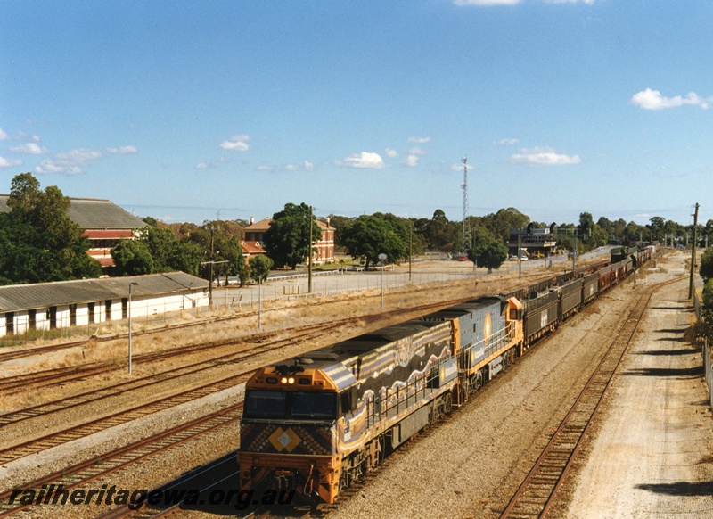 P18657
NR class 30 and 14 standard gauge diesel locomotives hauling an eastbound freight train through Midland. Both locomotives owned by National Rail and lead one painted in indigenous scheme and second one in charcoal grey and orange scheme. ER line. Photographed from overhead footbridge.
