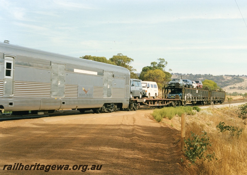 P18672
A flat-top and two double deck car carriers, loaded with passengers cars, attached to an eastbound Indian Pacific in the Toodyay area. ER line.
