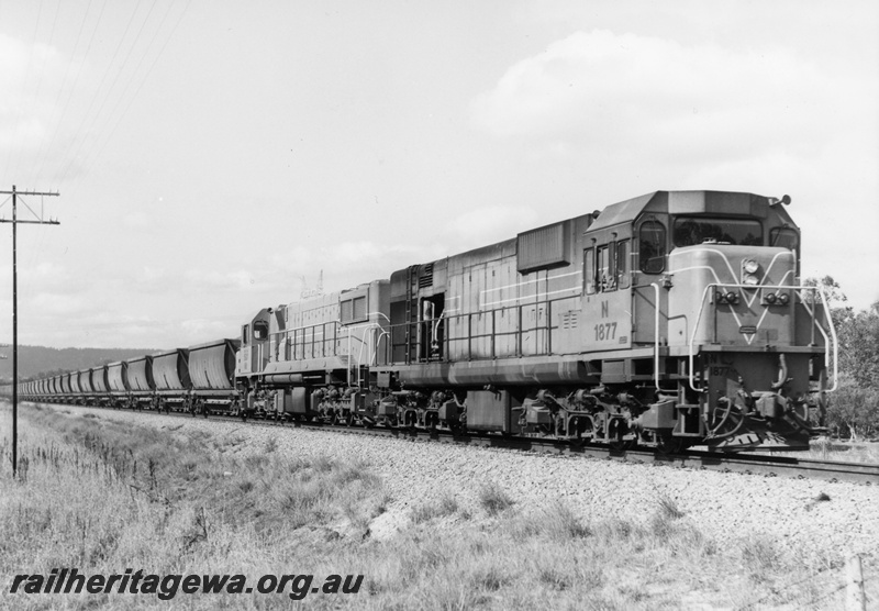 P18713
N class 1877, DB class diesel, in Westrail orange with white edged blue stripe, on bauxite train, side and front view
