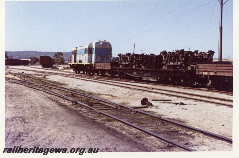 P18717
W class 958, on timber train, crossing concrete and steel bridge, side and front view
