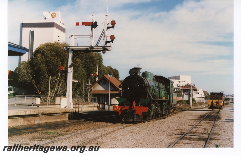 P18723
W class 908 'Dwellingup' steam locomotive, bracket signal with two shunting dollies, at the west end of Perth Station prior to operating a H.V.R. trip to Toodyay.
