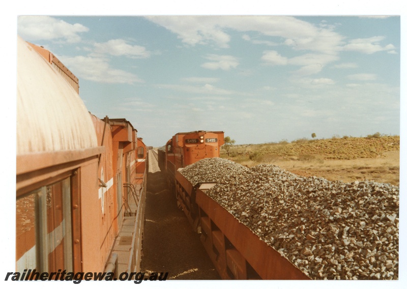 P18734
Mount Newman (MNM) M636 class 5495 on ballast train (Difco ballast wagons) at Turner. Photo taken from passing ore train. Derailment repairs - rear view.
