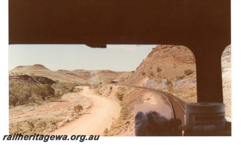 P18750
Mount Newman (MNM) drivers view of empty train travelling through the Chichester Range near Hesta siding
