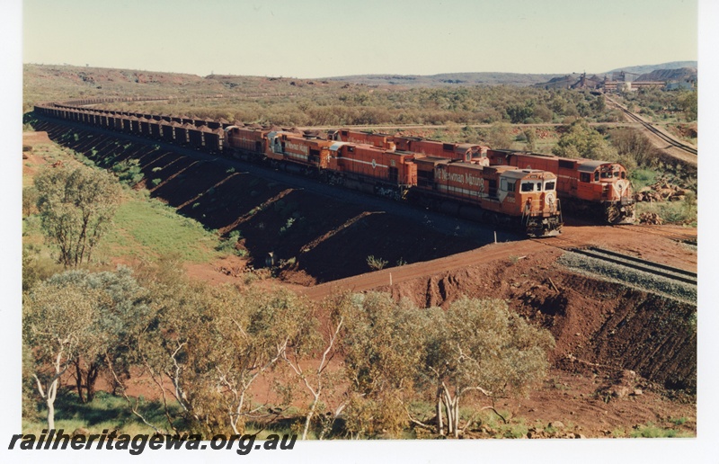 P18761
Mount Newman (MNM) C36-7M class 5510, M636 class 5487, C36-7M class 5513, M636 class 5469 -190 car train. Behind M636 class 5473, 5498,5471 250 car Locotrol at Newman. 
