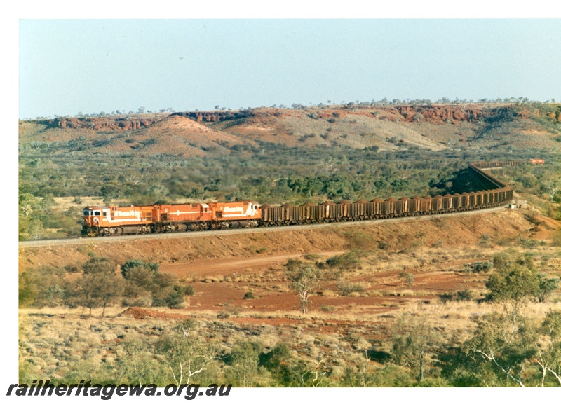 P18767
Mount Newman (MNM) C36-7M class 5507(lead loco), M636 class 5471(rear loco) haul a 192 car train past the 228kp. 
