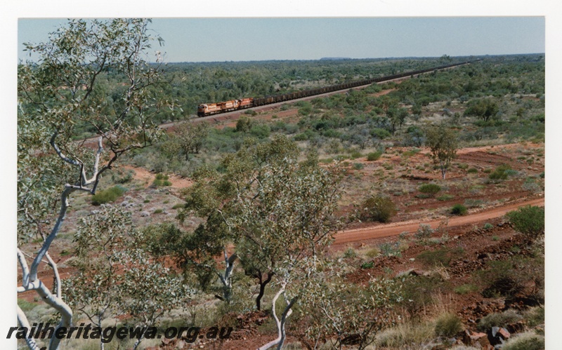 P18778
Mount Newman (MNM) CM39-8 class, C36-7M class, M636 class haul 240car loaded ore train past 403 kp. Full train in photo. 
