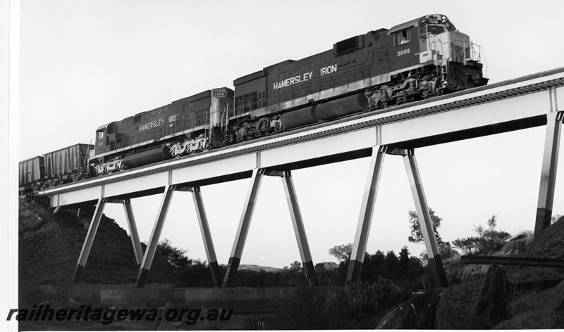 P18831
Hamersley iron (HI) C636 class 3006, C628 class 2005 haul loaded iron ore train over the Harding River near Emu. 
