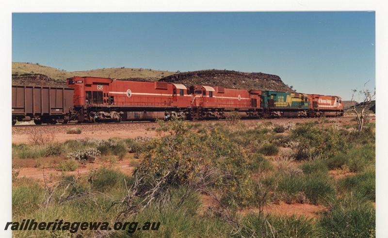 P18860
Mount Newman (MNM) M636 class 5502, 5488 (bi centenary livery), 5472, 5490 head an empty train at Garden. 
