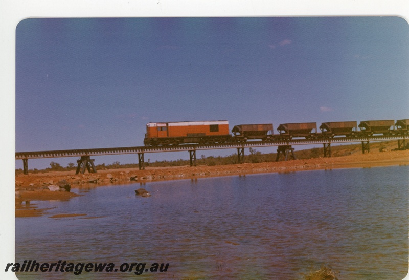 P18868
Goldsworthy Mining (GML) A class 8 hauls an empty ore train over the Tabba Tabba Creek en route to the mine at Goldsworthy. 
