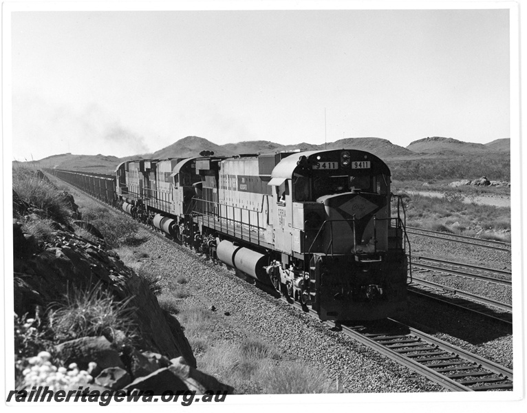 P18921
Cliffs Robe River (CRRIA) M636 class 9411 heads out of Cape Lambert with an empty ore train. 
