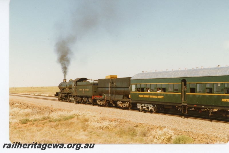 P18962
Hamersley Iron (HI) Pendennis Castle steam locomotive hauling passenger train between Dampier and Tom Price. Rear view of locomotive and passenger carriage.
