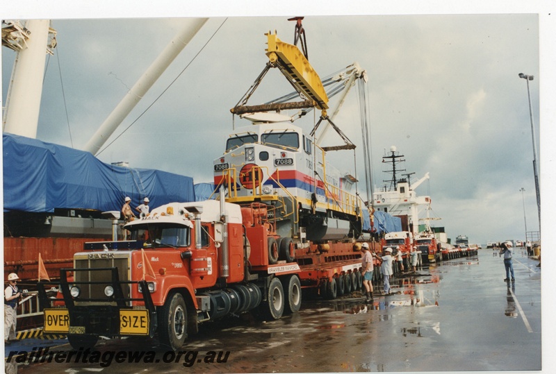 P19042
Hamersley Iron (HI) C44-9W class 7088 new locomotive being unloaded from heavy lift ship at Dampier wharf. 
