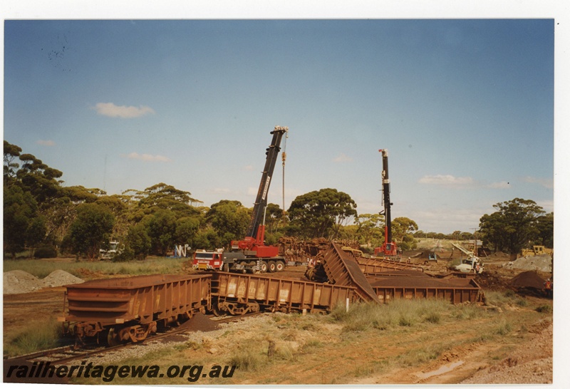 P19138
Iron ore train derailment near Salmon Gums. WO class wagons. Road crane lifting wagons off the main line. CE line. 
