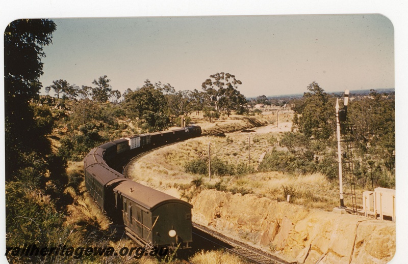 P19140
X class (all green livery) hauled passenger train near Swan View. Rear view of train photo taken from Swan View platform of train heading to Midland. Three position upper quadrant signal in photo. NR line.
