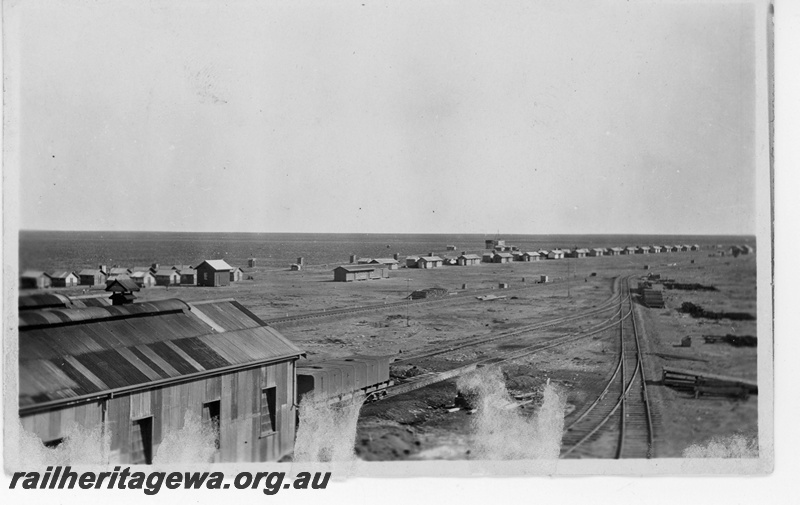 P19160
Overview of Cook townsite, Commonwealth Railways (CR) TD class water gin in front of the shed, yard, sheds, buildings, Cook, TAR line, from elevated position
