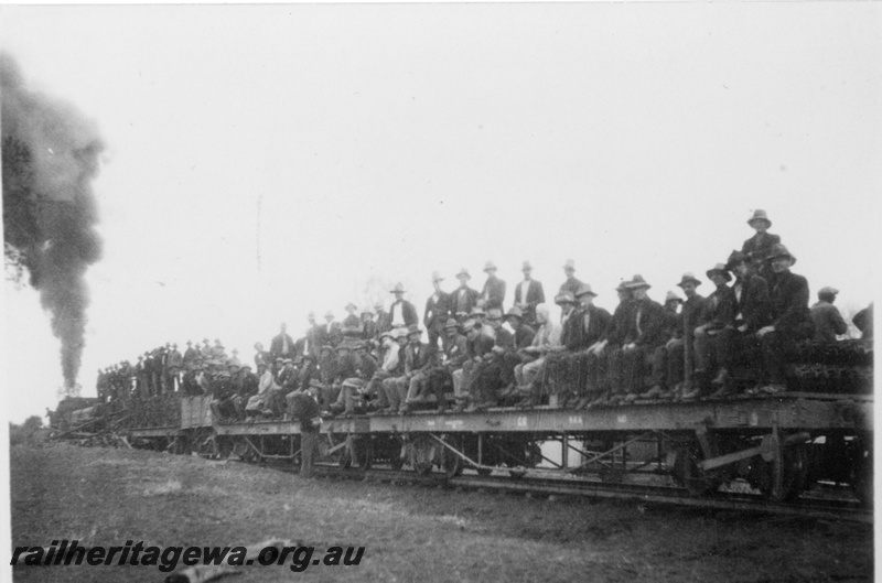 P19200
Commonwealth Railways (CR) steam hauled construction train comprising flat bed wagons with workers on board, near Port Augusta, TAR line
