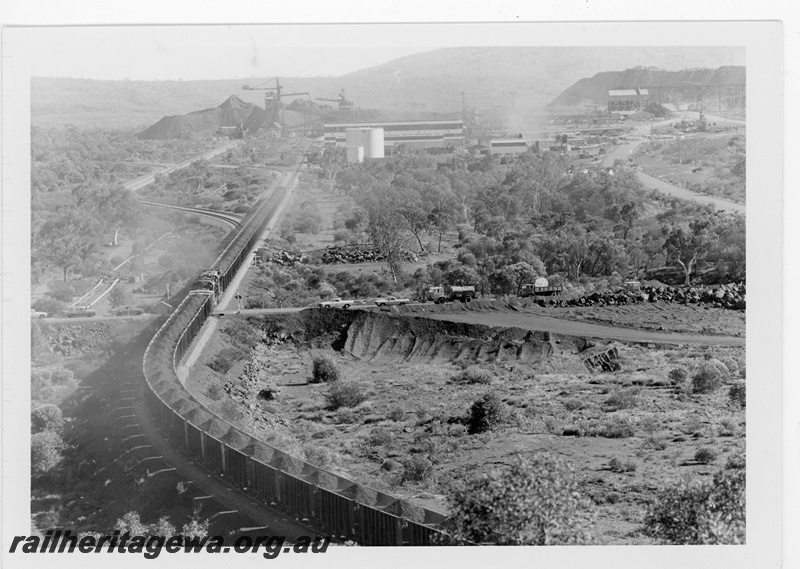 P19225
Mount Newman Mining (MNM) loaded ore train departing Newman . Photo shows Locotrol units in centre and rear of train.
