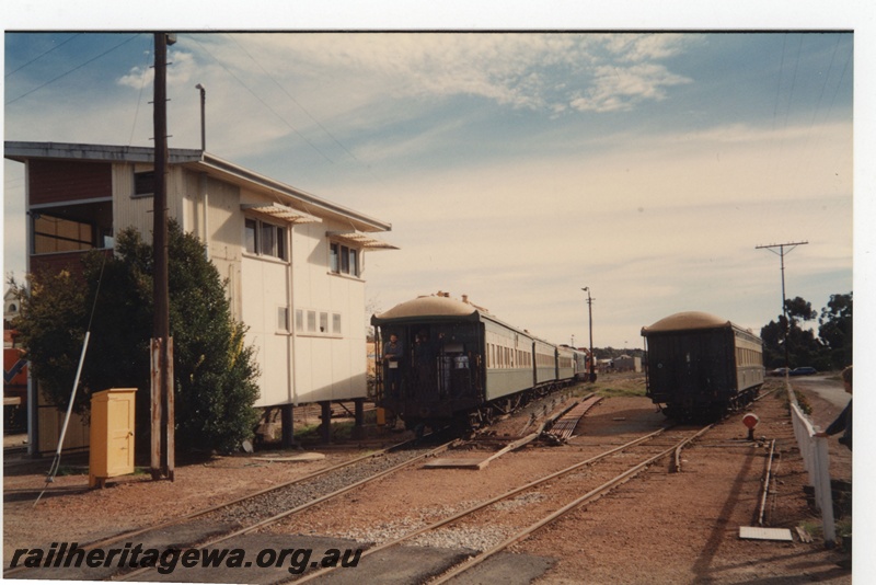 P19254
Signal box, sidings, carriages, crossing, point lever, rodding, Narrogin, GSR line, track level view 
