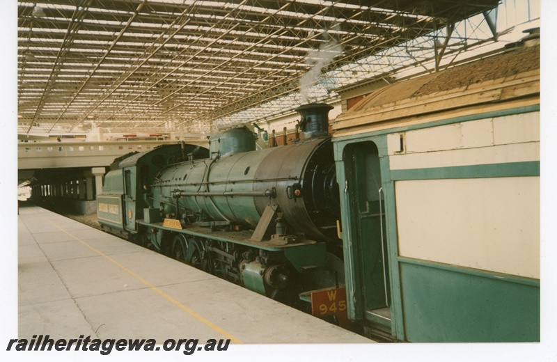 P19263
W class 945 with tender leading on tour train, under the new roof, pedestrian overpass, Perth station, side and front view from platform 
